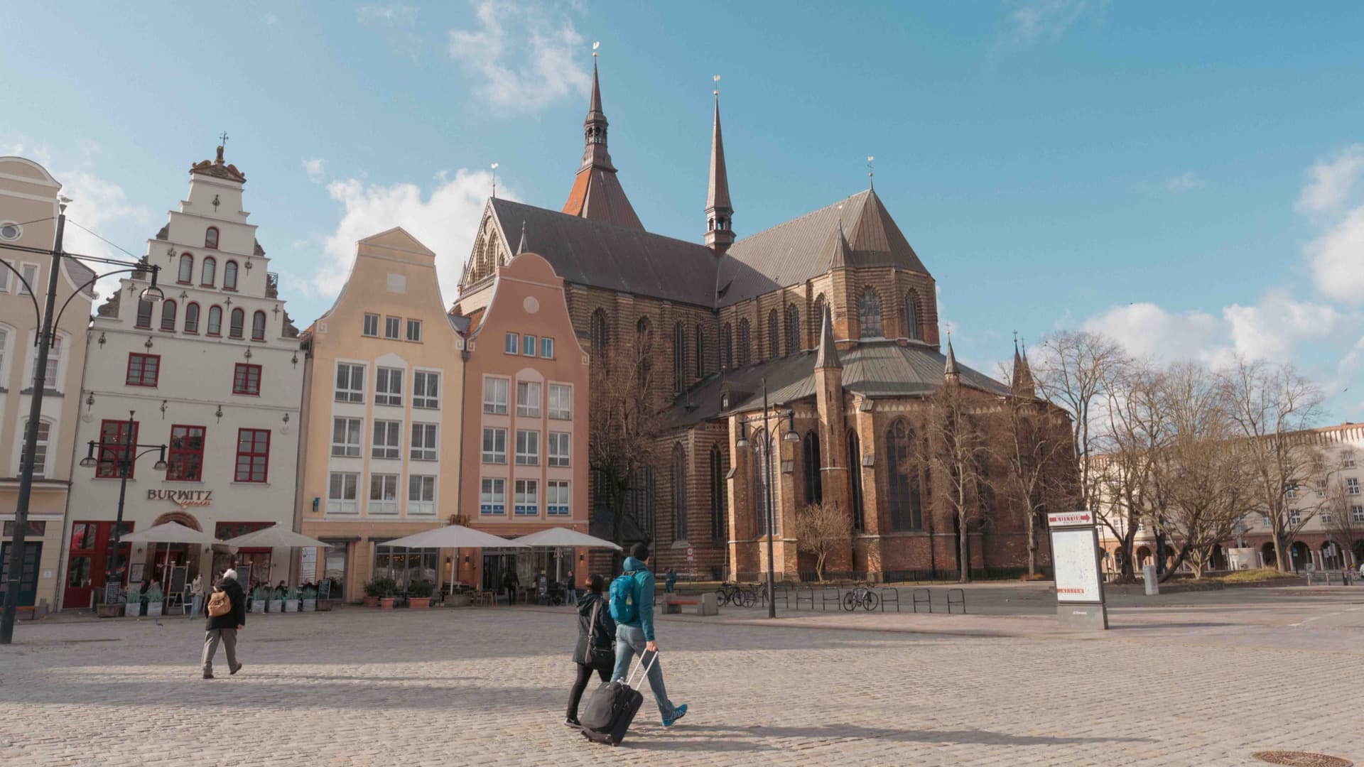 Rostock Neuer Markt square with historic red-brick Gothic city hall in winter